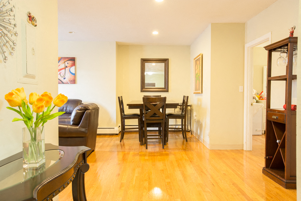 a living room and dining room with a table and chairs